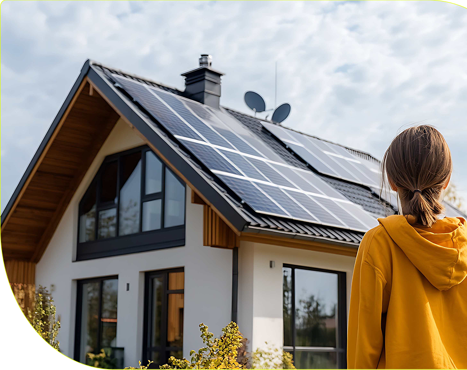 Girl looks at house with solar panels on it