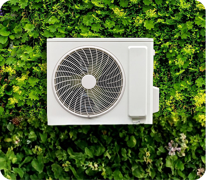 Air source heat pump with green leaves around it