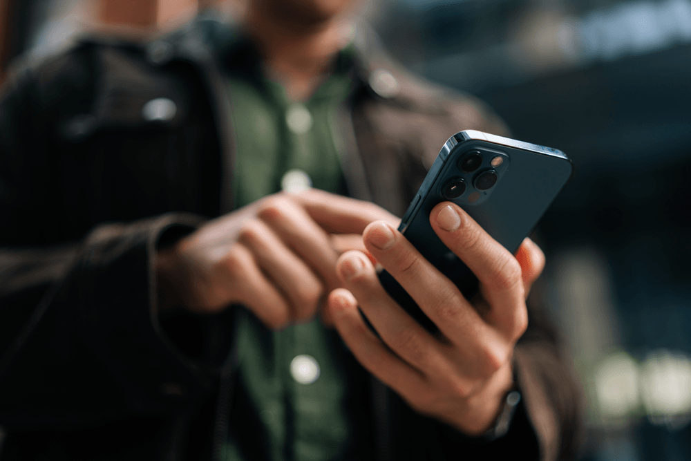 Man on phone using the Octopus app.